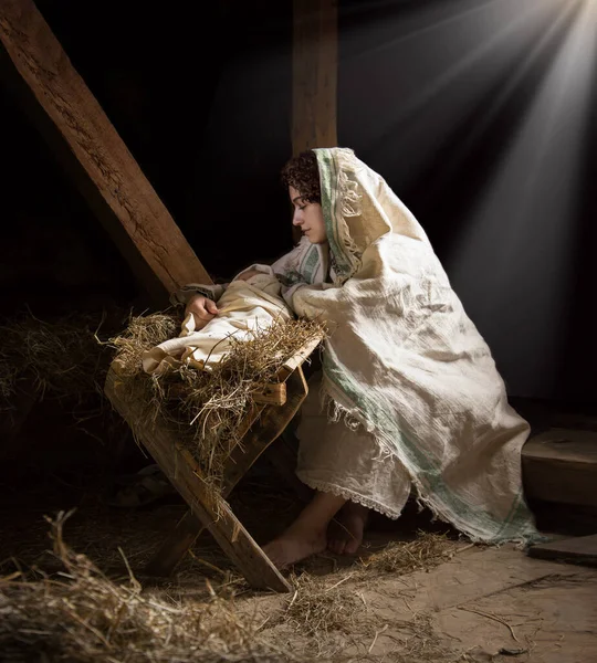 Happy young boy cradle sleep life symbol star light white cloth greet card text space. Dark black stable barn cave hay straw live scene cute new parent merry Lord messiah noel eve love joy lady hand