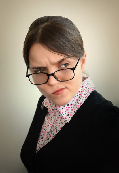 Young girl with a sour face suspiciously looking away