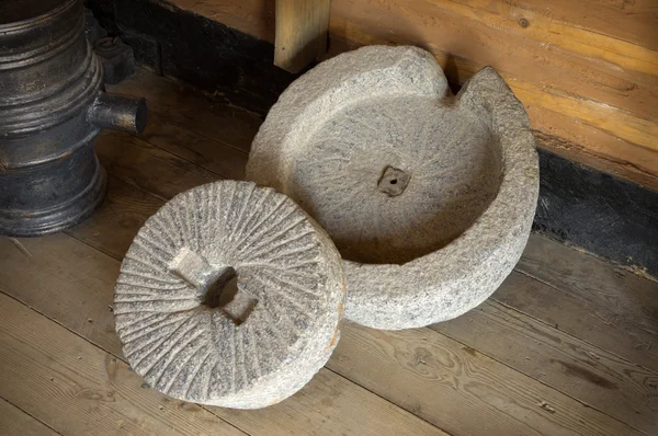 Ancient millstone in wooden barn — Stock Photo, Image