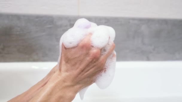 Κοντινό Πλάνο Man Hand Κρατώντας Σφουγγάρι Αφρό Στο Μπάνιο Σφίξιμο — Αρχείο Βίντεο