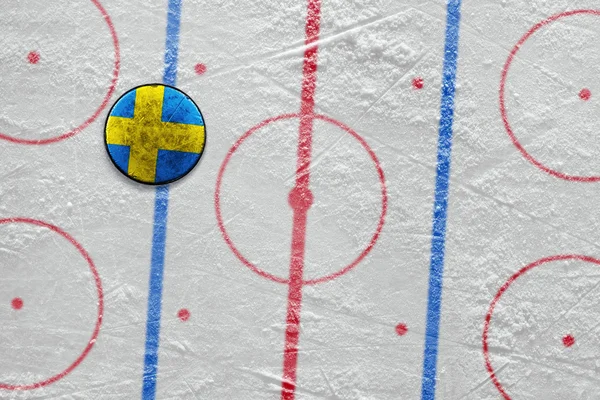 Swedish hockey puck lying on the floor — Zdjęcie stockowe