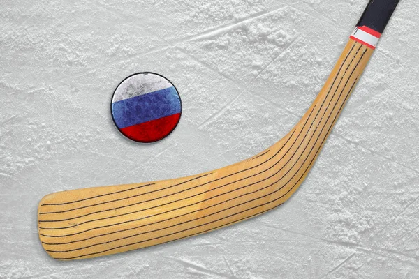 Hockey stick and puck on the Russian hockey rink — Stock Photo, Image