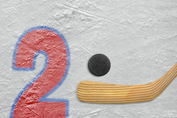 Hockey stick, puck and the numeral two — Stock Photo, Image