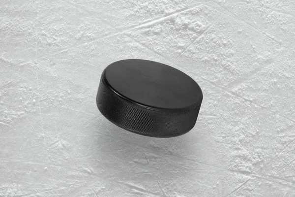 Hockey puck on ice — Stock Photo, Image
