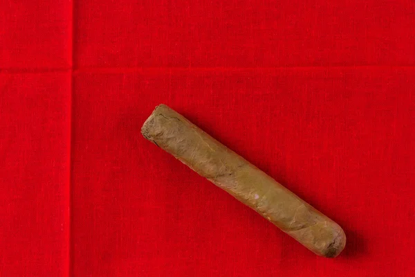 Cigar on red cloth — Stock Photo, Image