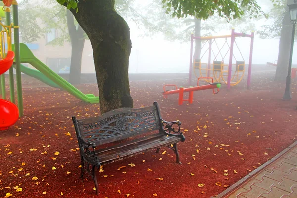 Bench near playground in foggy Sighnaghi, Georgia — Stock Photo, Image