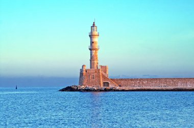 Old venetian lighthouse of Chania in Crete, Greece on the sunris clipart
