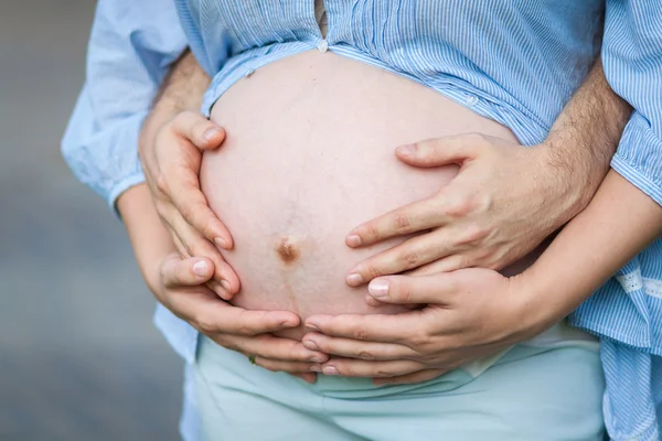 Man and woman hugging belly, closeup — Stock Photo, Image