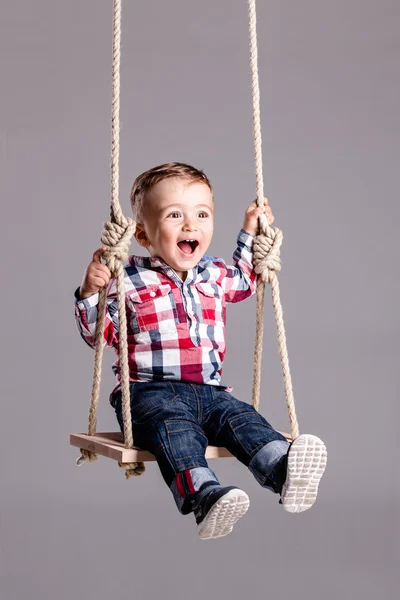 Niño en un columpio — Foto de Stock