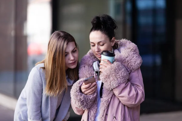 Twee Meisjes Die Naar Telefoon Kijken Vrienden Roddelen Buiten Een — Stockfoto