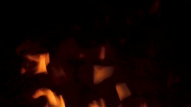 Bacada ateş yanıyor. Karanlıkta soyut ağır çekim alevleri.