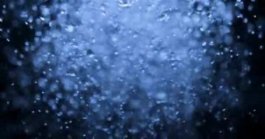 Hypnotic Slow Motion of Numerous Water Drops and Bubbles Cascading and Splashing, Forming a Dynamic and Abstract Liquid Texture Against a Soft, Out-of-Focus Background