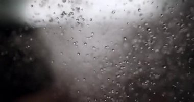 Hypnotic Slow Motion of Numerous Water Drops and Bubbles Cascading and Splashing, Forming a Dynamic and Abstract Liquid Texture Against a Soft, Out-of-Focus Background
