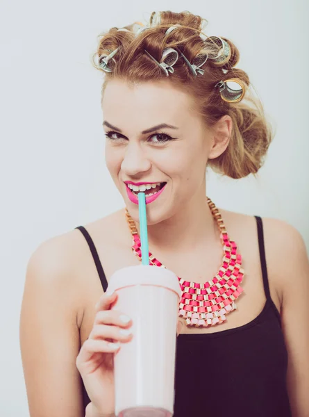 Щаслива молода жінка п'є, використовуючи соломинку. Керрі на волоссі . — стокове фото