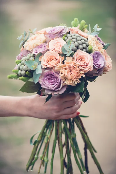 婚礼花束特写镜头，美丽温柔婚礼花束的混合花和新娘的手 — 图库照片