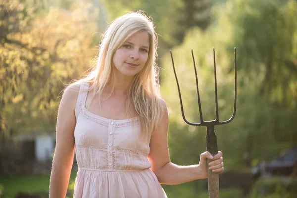 Young woman with pitchfork — Stock Photo, Image
