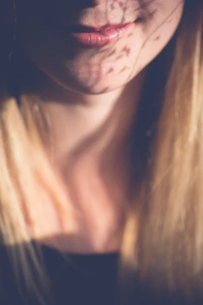 Close up portrait. Woman mouth with flower shadows. — Stock Photo, Image