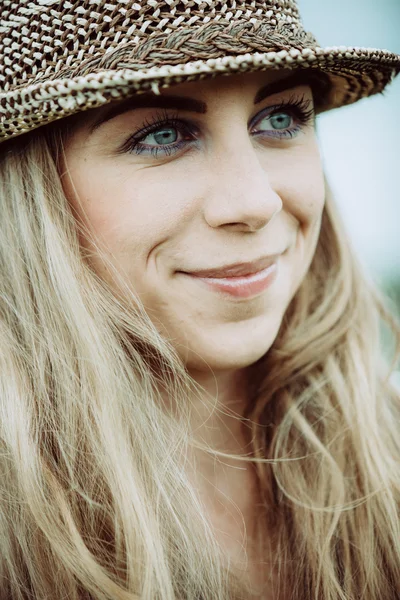 Portrait of pretty cheerful woman wearing white dress and straw hat in sunny warm weather day. Walking at summer park and smiling — Stock Photo, Image