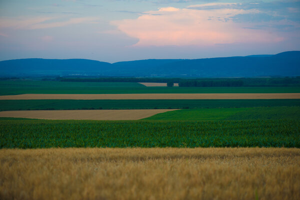 Закат над сельскохозяйственными землями
