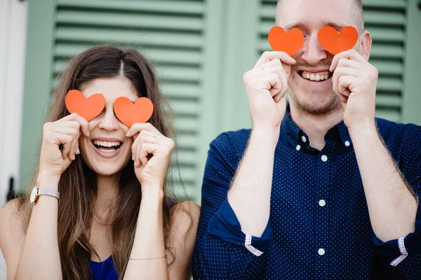 Couple holding red heart symbols — Stock Photo, Image