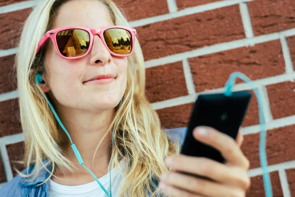 Chica escuchando música desde el teléfono inteligente —  Fotos de Stock