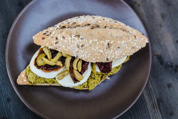Gourmet sandwich with pesto sauce and olives — Stock Photo, Image