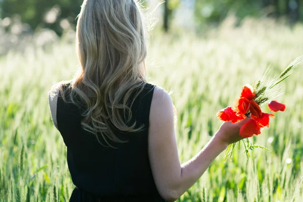 Жінка збирає квіти на відкритому повітрі — стокове фото