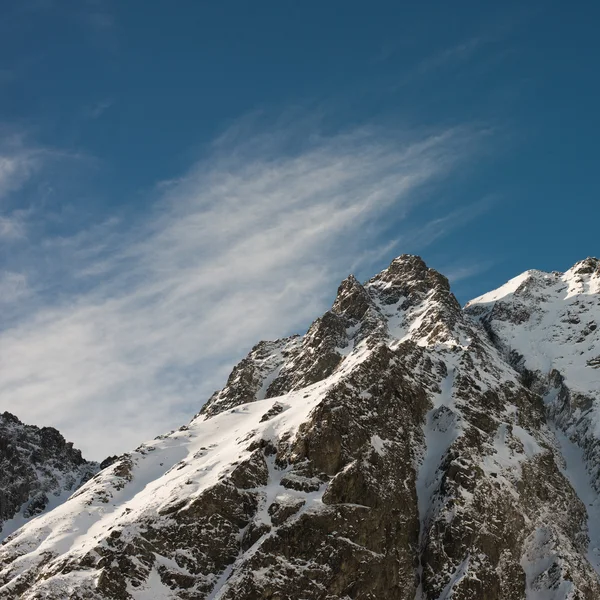 Сцена высокой горы с голубым небом и высокой вершиной — стоковое фото