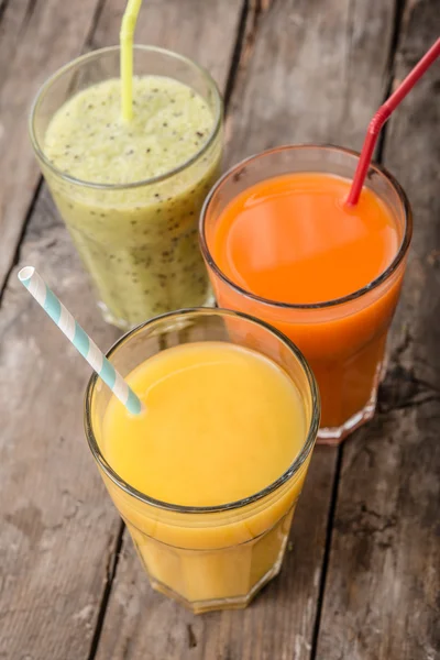 Three Smoothie on wooden background — Stock Photo, Image