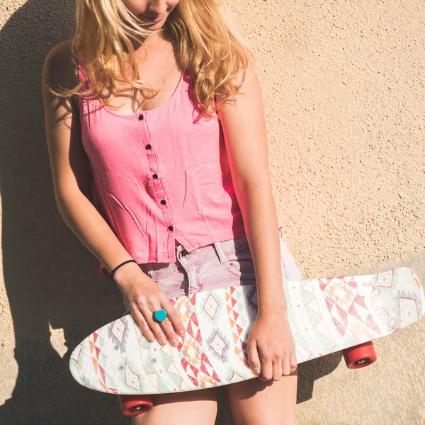 Blonde skateboarder vrouw poseren buiten — Stockfoto