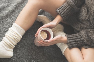 Woman in bed with a cup of tea