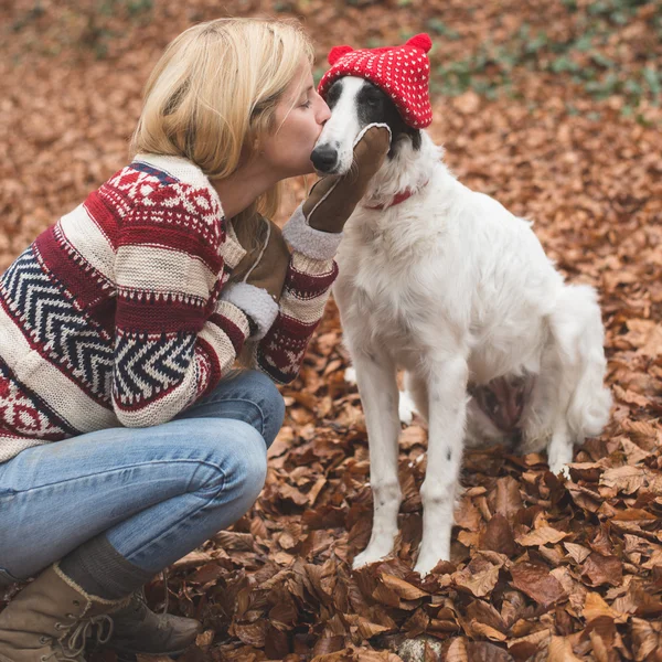 Woman embraced and kissing     Borzoi dog — стокове фото