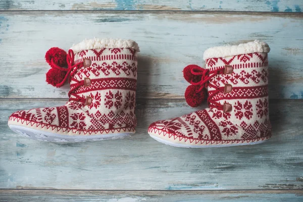 Cozy Christmas slippers on vintage wooden floor — Stock Photo, Image