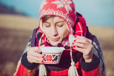 Winter girl drinking tea or coffee