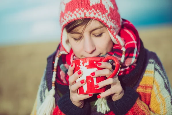 Winter girl drinking tea or coffee — Stok fotoğraf