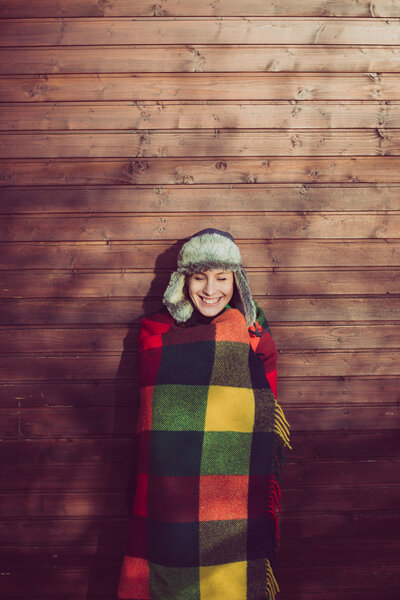 Young woman under a warm blanket