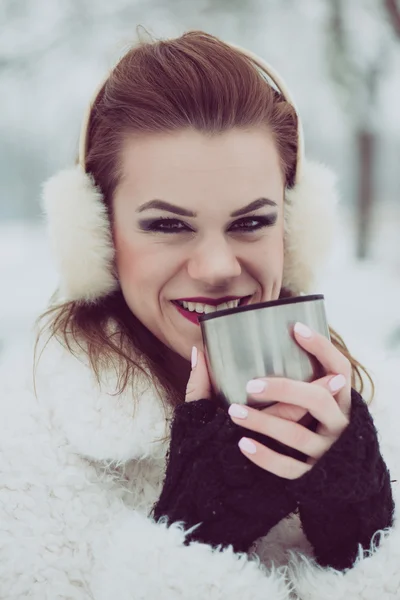 Close up portrait of young woman drinking hot tea or coffee outdoor, vintage winter vacation concept — Stock Photo, Image