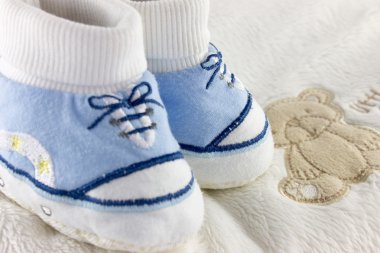 Baby stuff and shoes isolated on white clipart