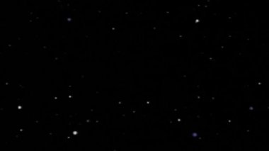 Siyah bir zemin üzerine küçük parçacıkların animasyonlu hareket