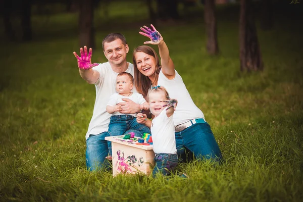 Happy family with nesting box and paints — Stock Photo, Image