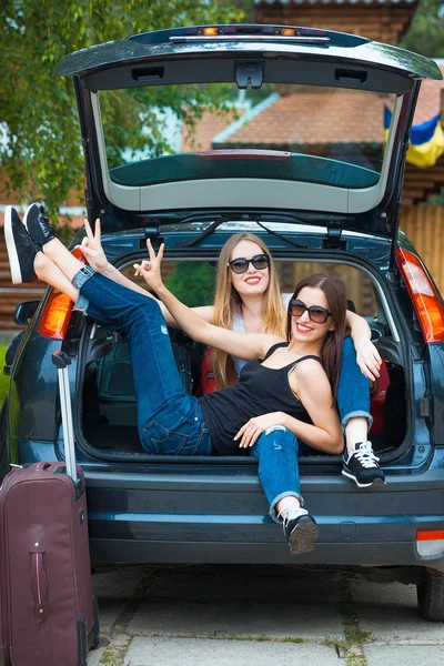 Two girls posing in car