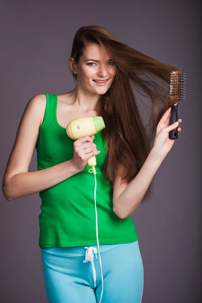 Woman with hair dryer — Stock Photo, Image