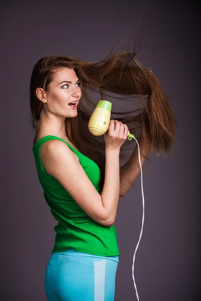 Woman with hair dryer — Stock Photo, Image