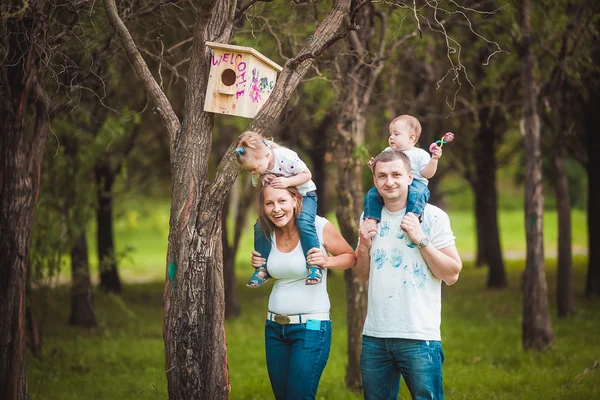 Familia feliz con pajarera de madera —  Fotos de Stock