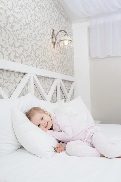 Little child girl in soft bed — Stock Photo, Image