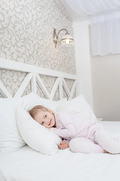 Little child girl in soft bed — Stock Photo, Image