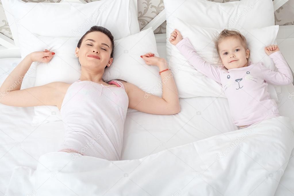 Mother and daughter in bed