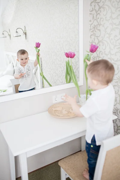 Cute baby boy with tulip — Stock Photo, Image