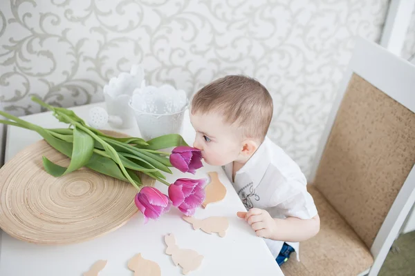 Cute baby boy with tulip — Stock Photo, Image