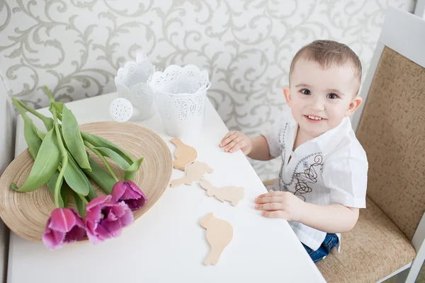 Cute baby boy with tulip — Stock Photo, Image